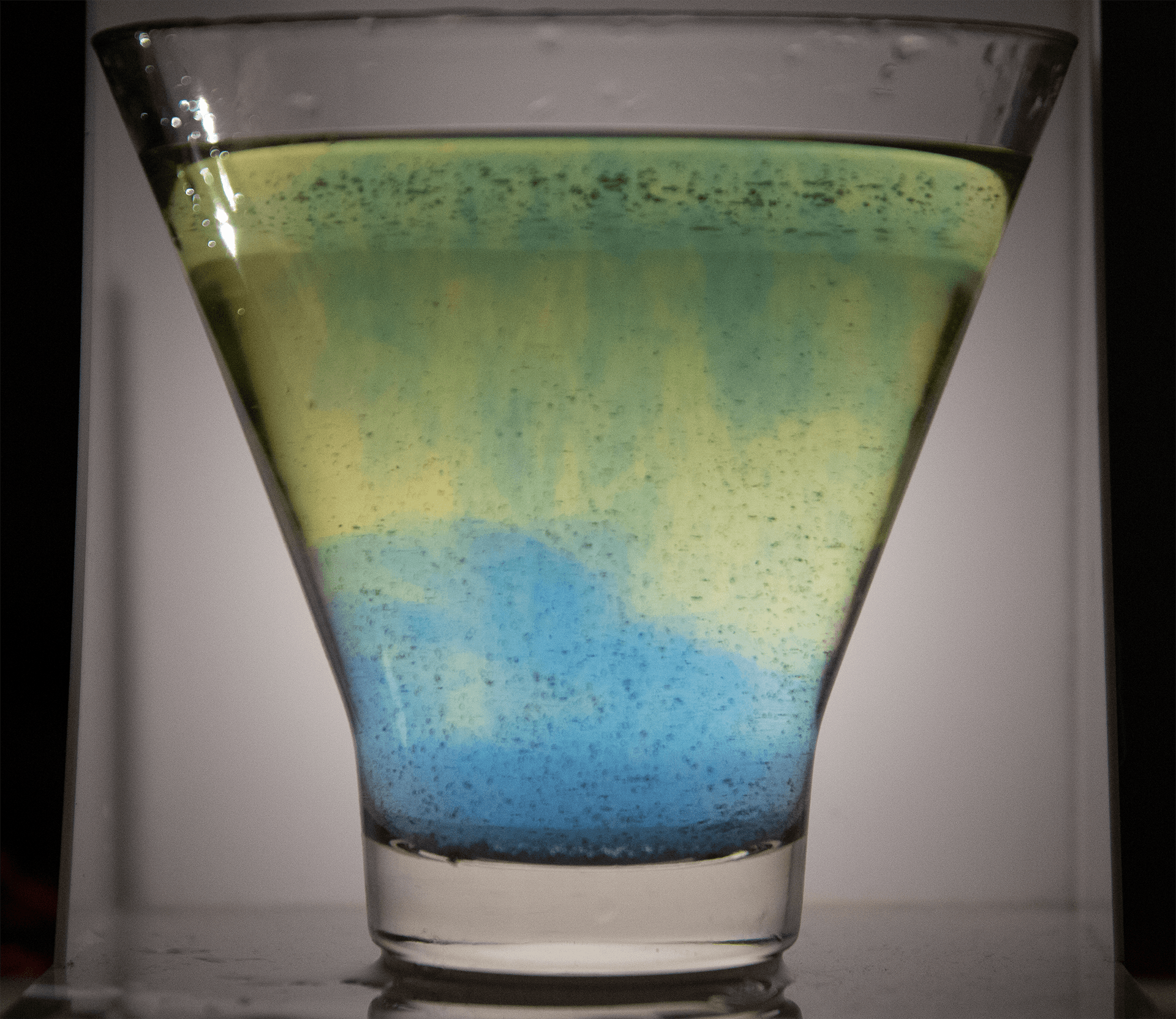 Using a pH indicator to change a glass of liquid from yellow to blue.  Here, bubbles were blown into the liquid to make it acidic, turning it yellow, and Oxyclean is added gradually making it basic and turning it blue.  The hue and saturation of this liquid can be measured and used to modulate sounds.