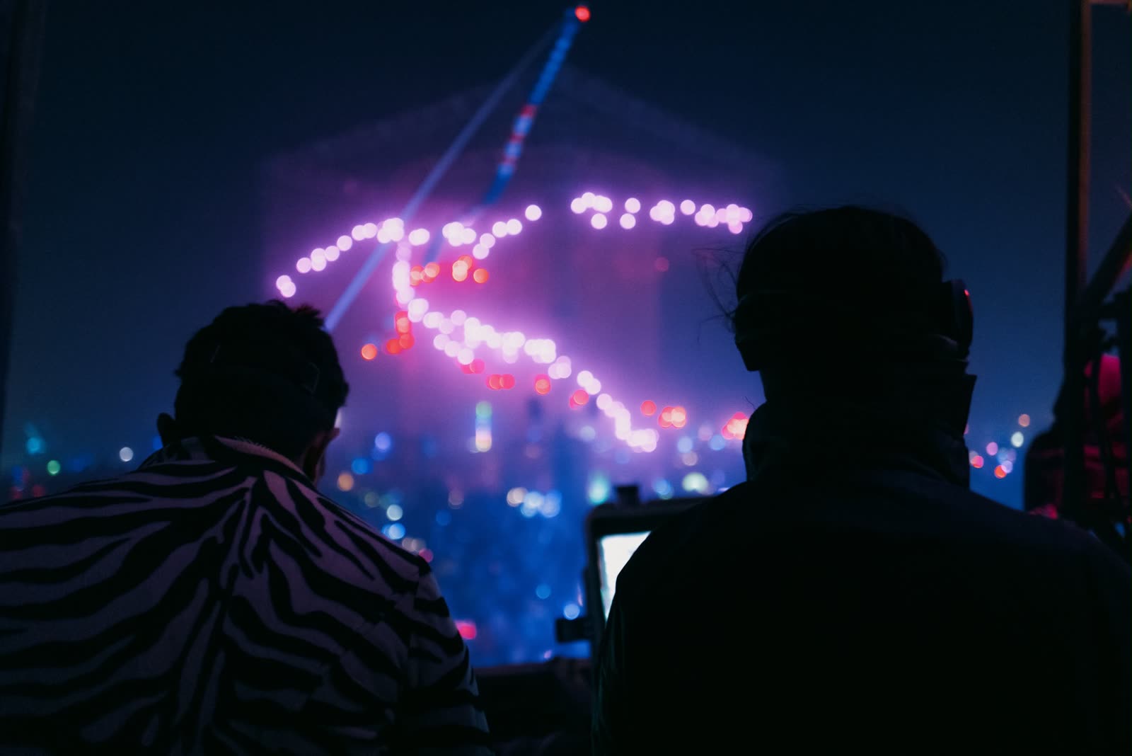 Two silhouettes on the bus, the heart lit in the distance